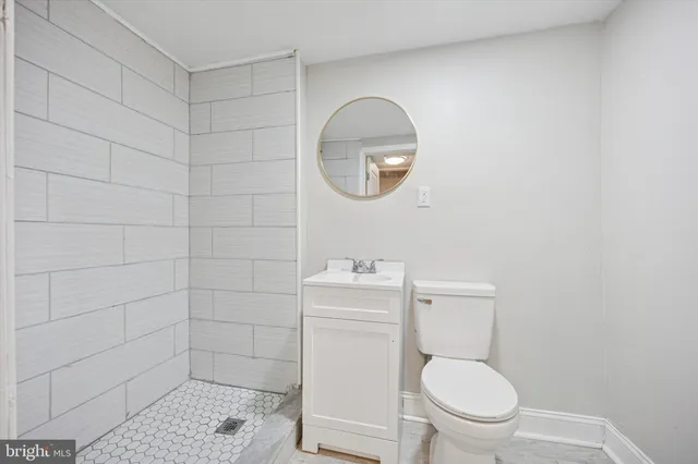 a white toilet sitting next to a bathroom sink