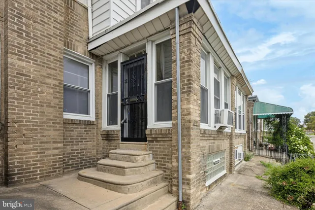 a view of a brick house with many windows