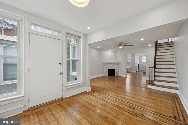 a view of livingroom with hardwood floor and kitchen view