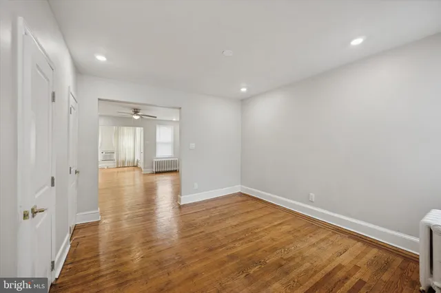 a view of a room with wooden floor and window