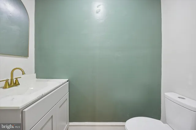 a bathroom with a sink a toilet and mirror