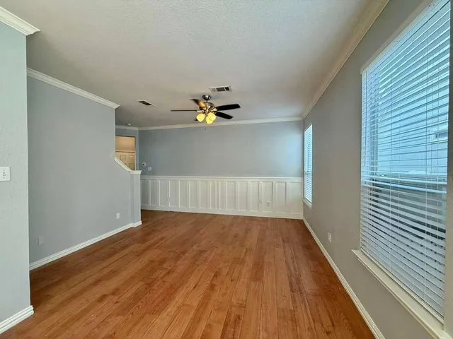a view of a room with wooden floor