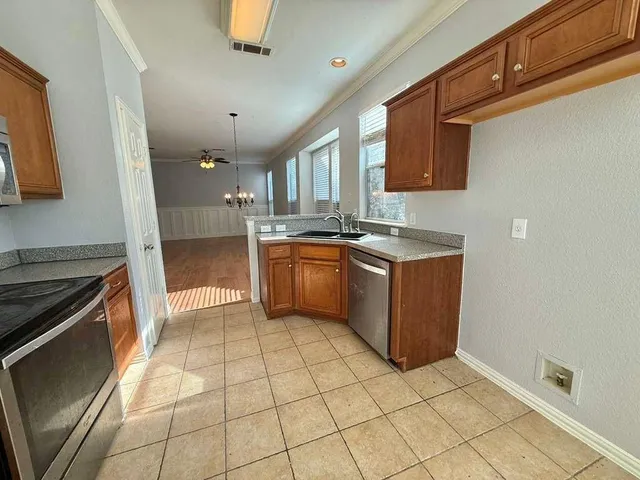 a kitchen with stainless steel appliances granite countertop a sink and a stove