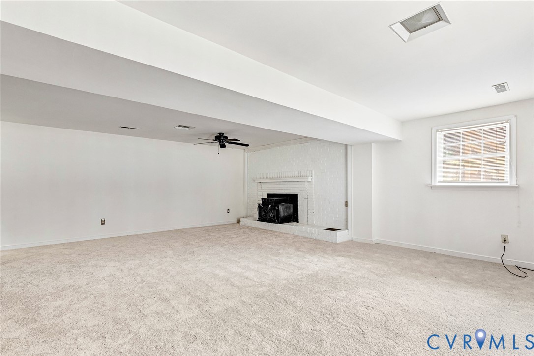 9107 Mossy Brook Road Mechanicsville, VA 23116 - Photo 12 of 30 Unfurnished living room featuring ceiling fan, car