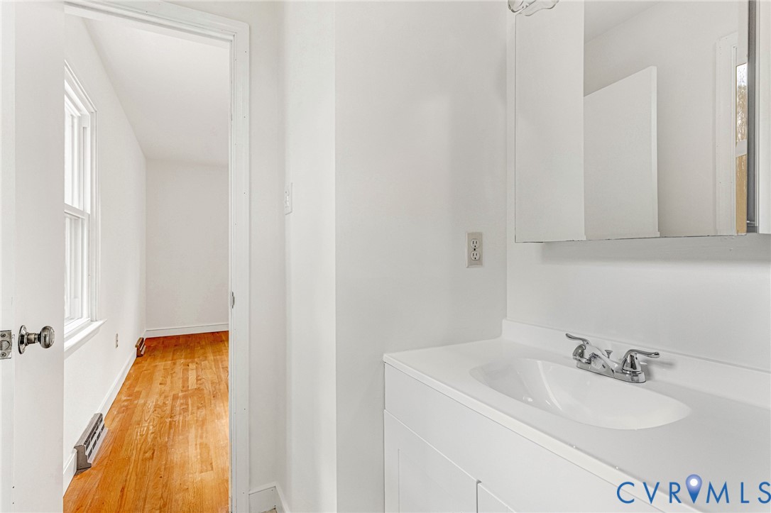 9107 Mossy Brook Road Mechanicsville, VA 23116 - Photo 18 of 30 Bathroom featuring vanity and light wood finished