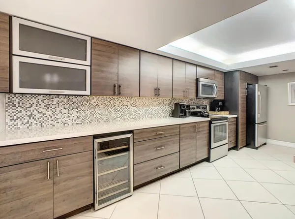 a kitchen with granite countertop cabinets and steel stainless steel appliances