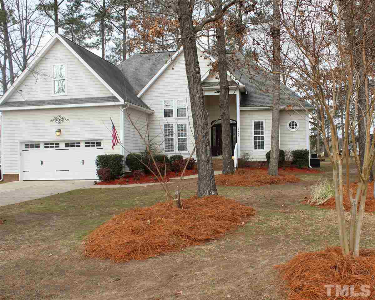 6904 Field Hill Road Raleigh, NC 27603 - Photo 2 of 25 a view of a yard in front of a house with a large tree