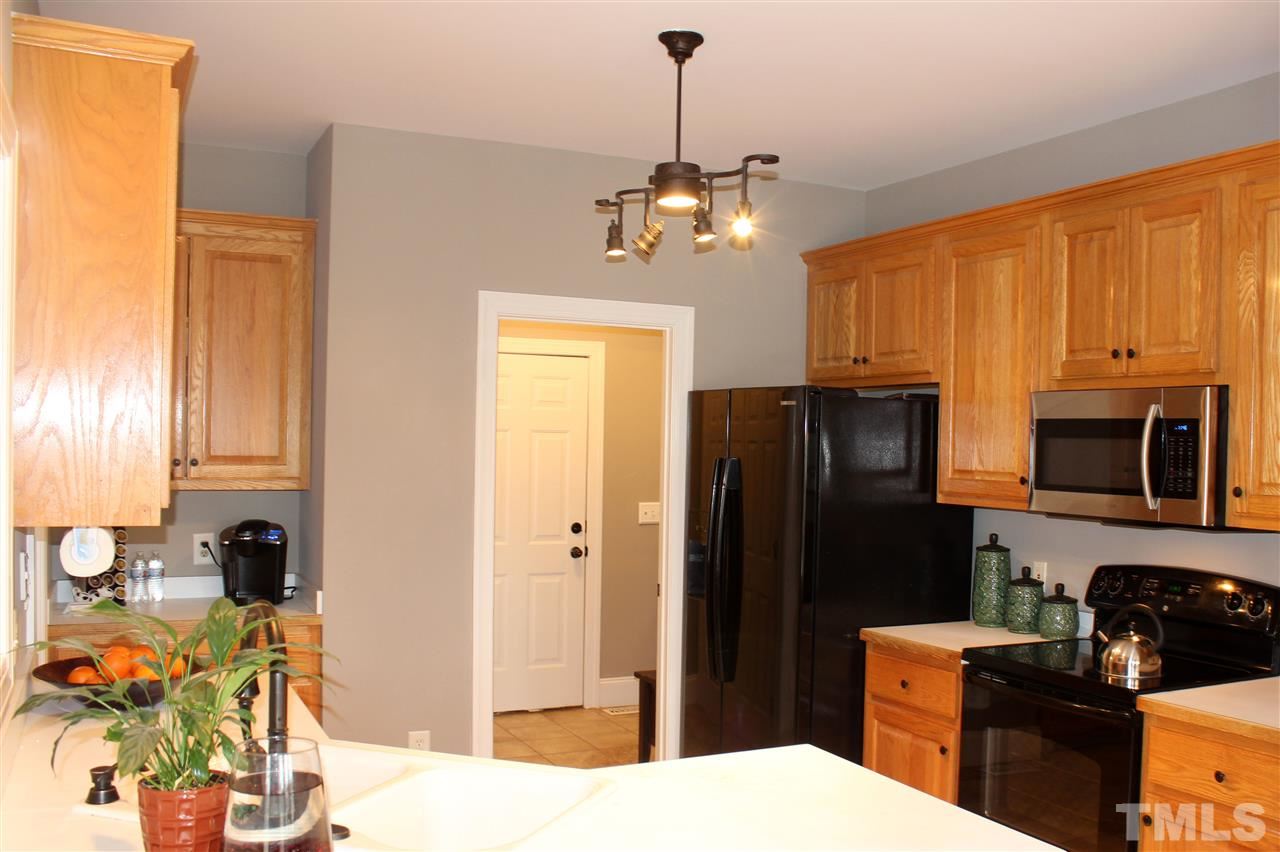 6904 Field Hill Road Raleigh, NC 27603 - Photo 11 of 25 a kitchen with stainless steel appliances a refrigerator sink and microwave