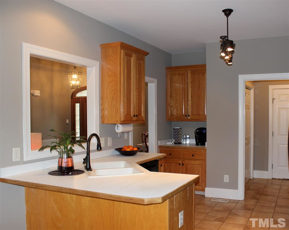 6904 Field Hill Road Raleigh, NC 27603 - Photo 12 of 25 a kitchen with a sink and a refrigerator