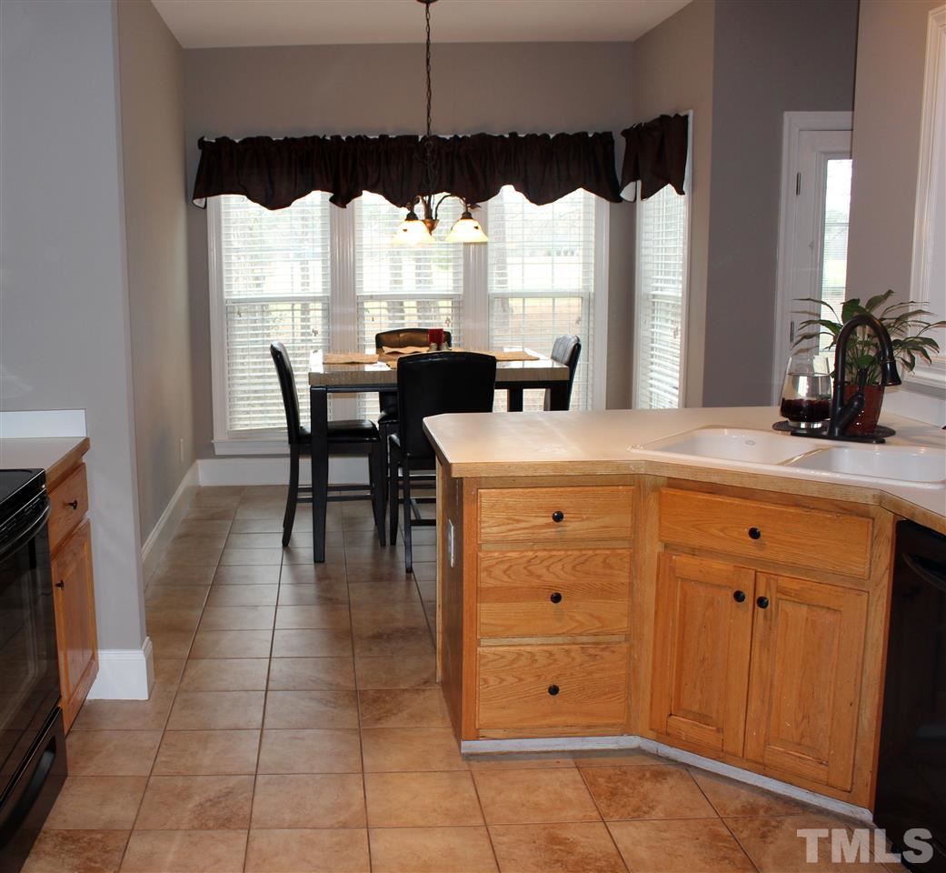 6904 Field Hill Road Raleigh, NC 27603 - Photo 13 of 25 a kitchen with a table chairs and a window