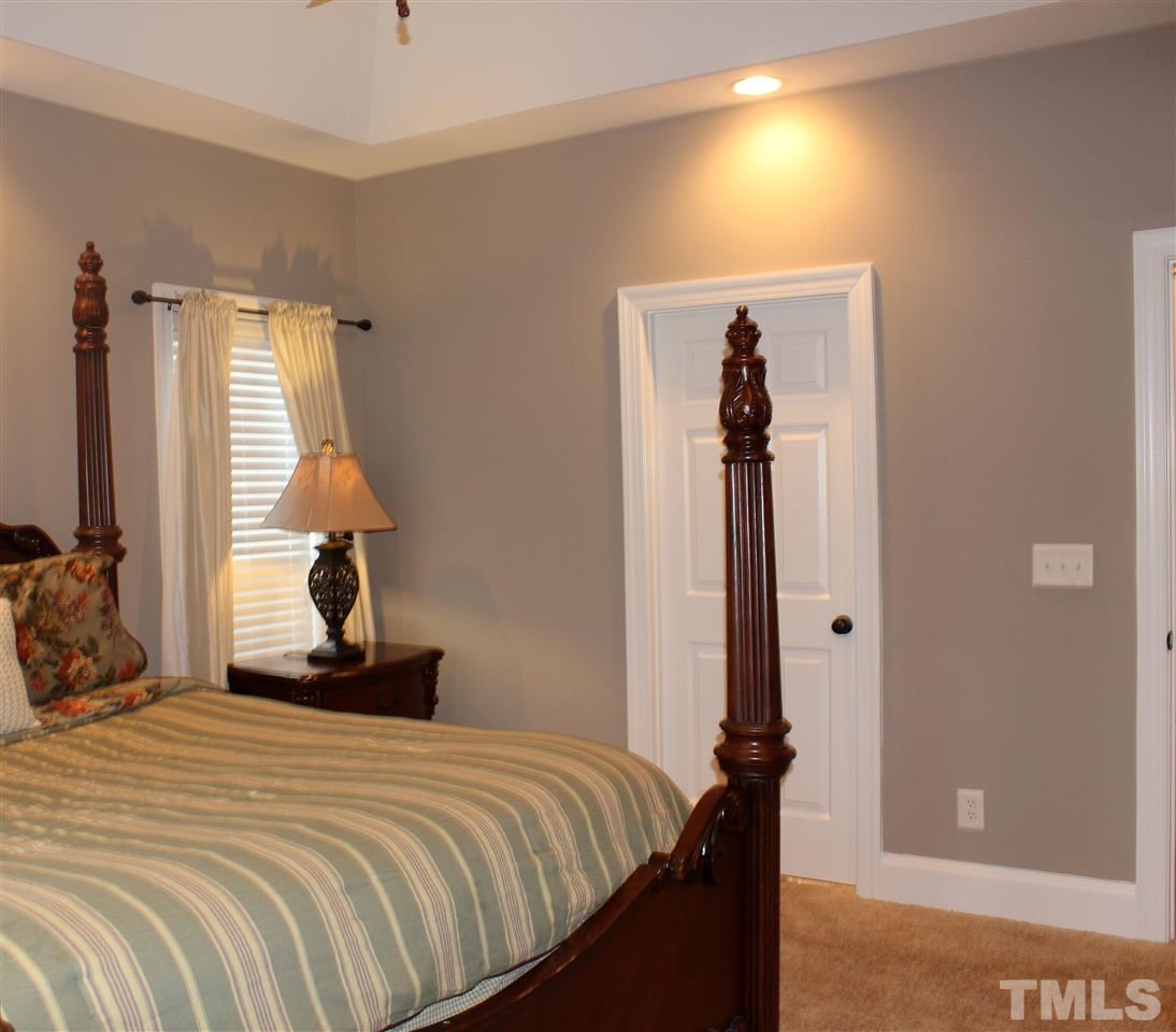 6904 Field Hill Road Raleigh, NC 27603 - Photo 16 of 25 a bedroom with a bed and a window