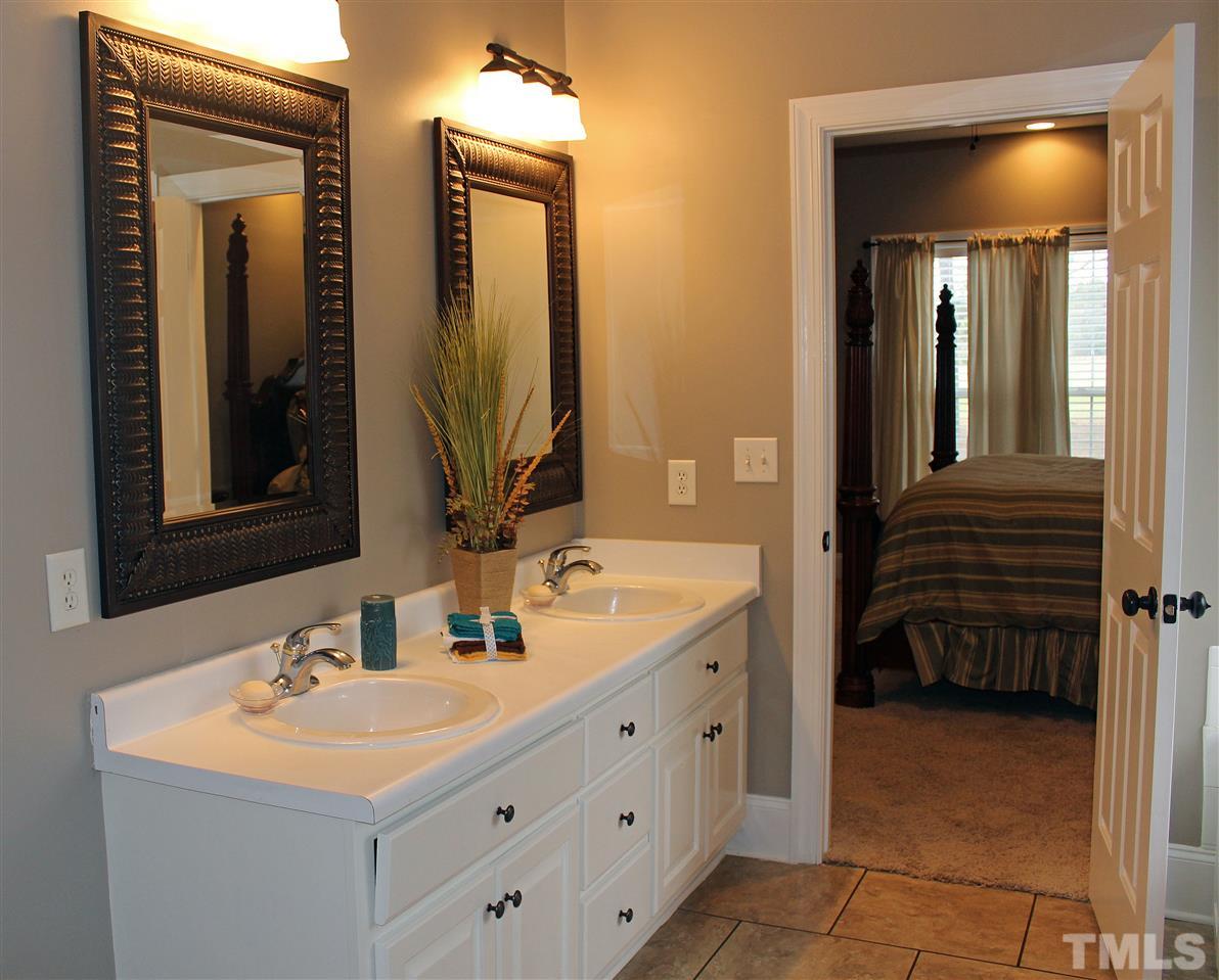 6904 Field Hill Road Raleigh, NC 27603 - Photo 17 of 25 a bathroom with a sink and a mirror