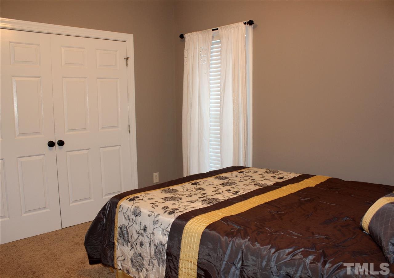 6904 Field Hill Road Raleigh, NC 27603 - Photo 19 of 25 a bedroom with a bed and a window