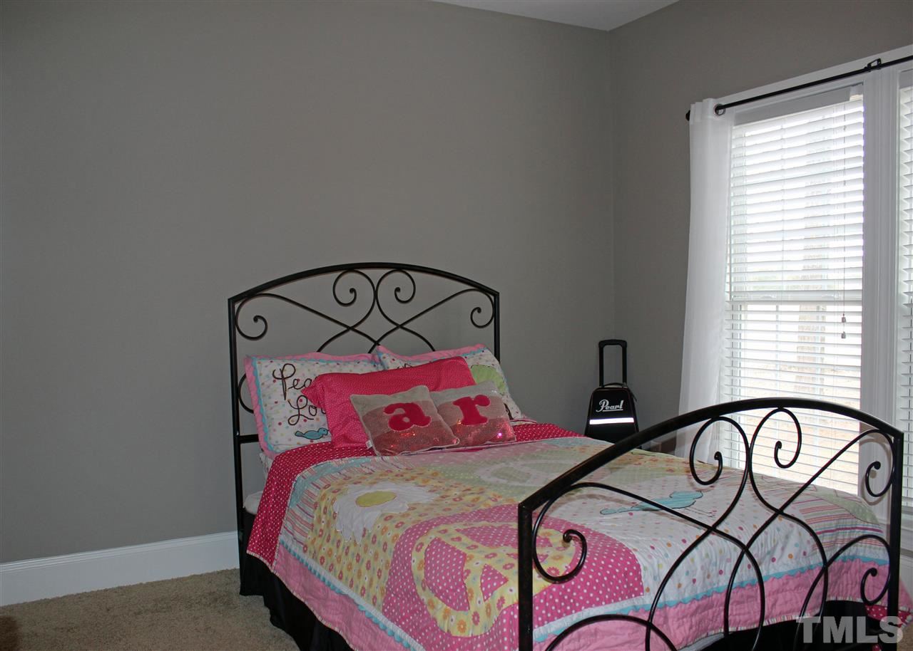 6904 Field Hill Road Raleigh, NC 27603 - Photo 20 of 25 a bedroom with a bed and a dresser in it