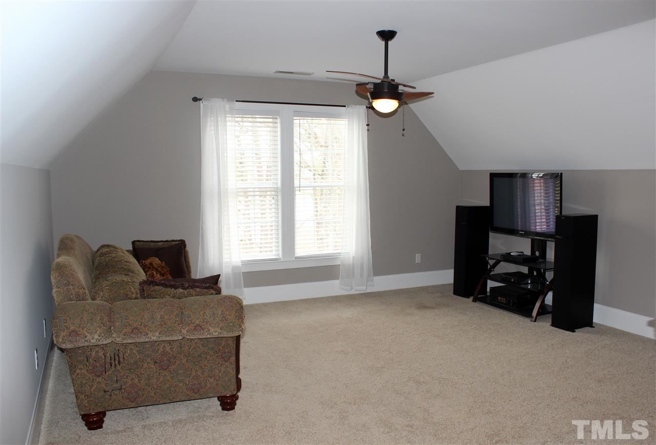 6904 Field Hill Road Raleigh, NC 27603 - Photo 22 of 25 a living room with furniture and a flat screen tv