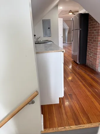 a view of a hallway with wooden floor