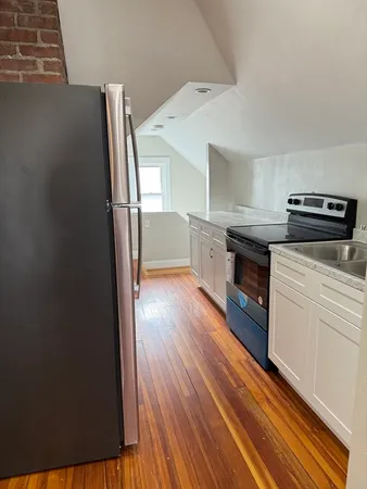a kitchen with a refrigerator and a stove