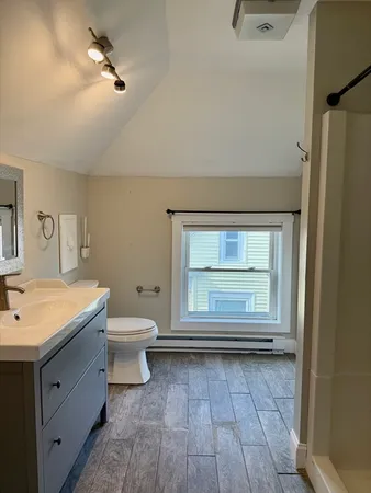a bathroom with a toilet sink and mirror