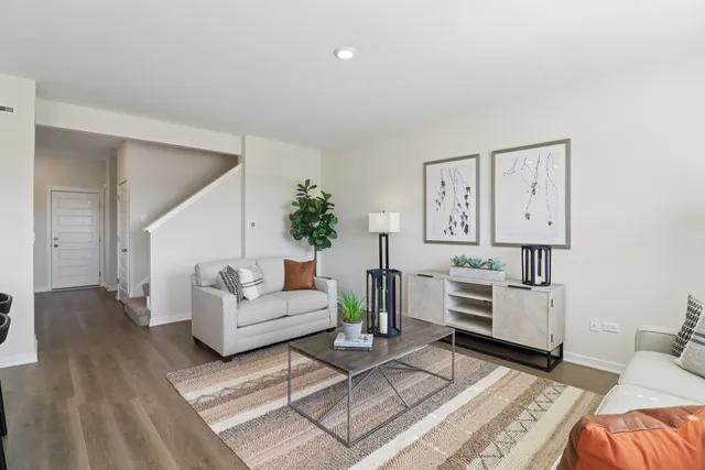 a living room with furniture and wooden floor