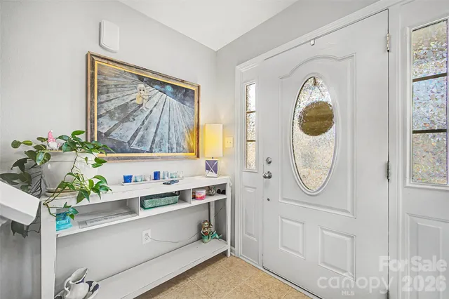 a view of washer and dryer with bathroom in the background
