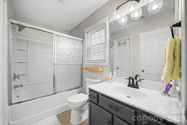 a view of a hallway with wooden floor and entryway
