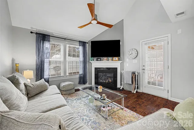 a living room with fireplace furniture and a flat screen tv