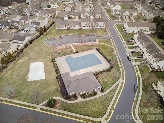 an aerial view of residential houses with outdoor space and seating