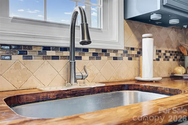 a dining room with furniture a fireplace and wooden floor