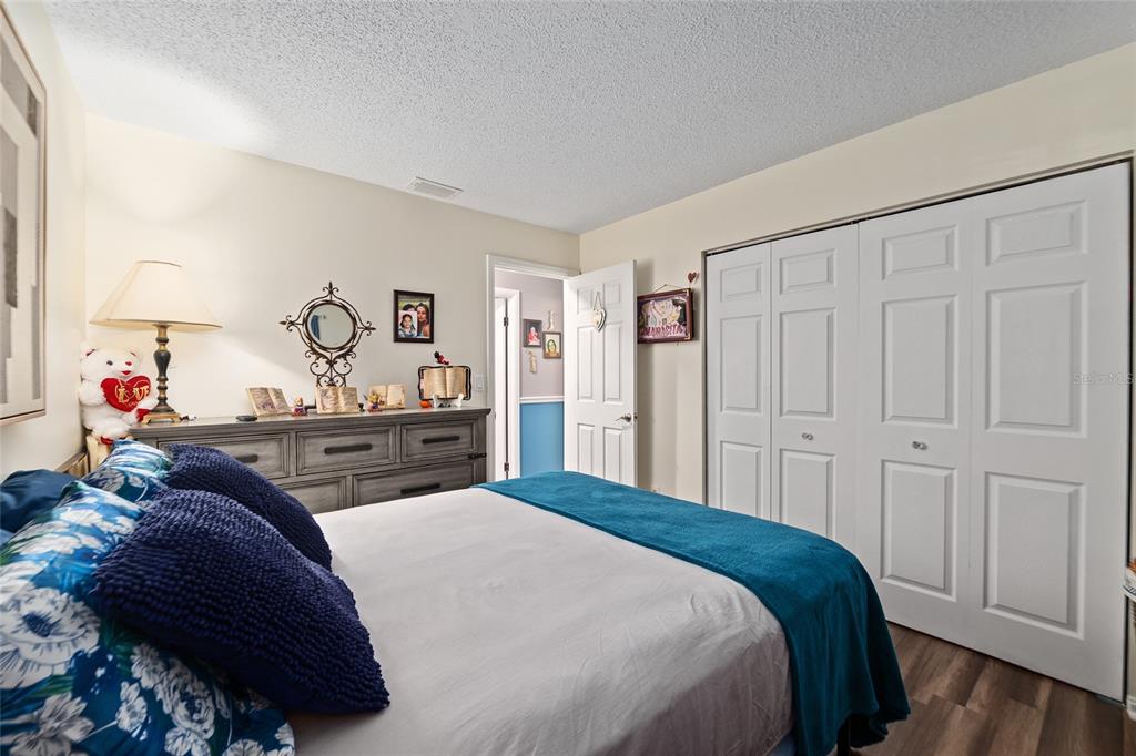 10182 Southwest 88th Court Ocala, FL 34481 - Photo 22 of 31 a bedroom with a bed and a dresser