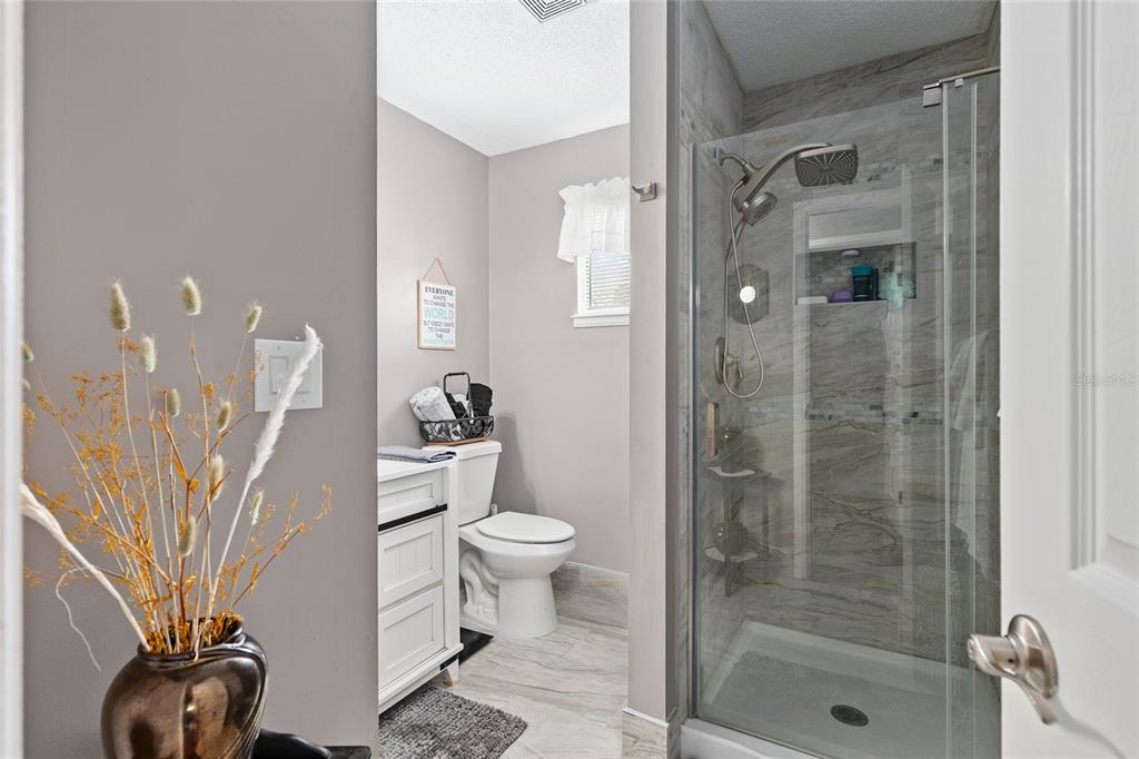 10182 Southwest 88th Court Ocala, FL 34481 - Photo 23 of 31 a bathroom with a shower a toilet and a sink