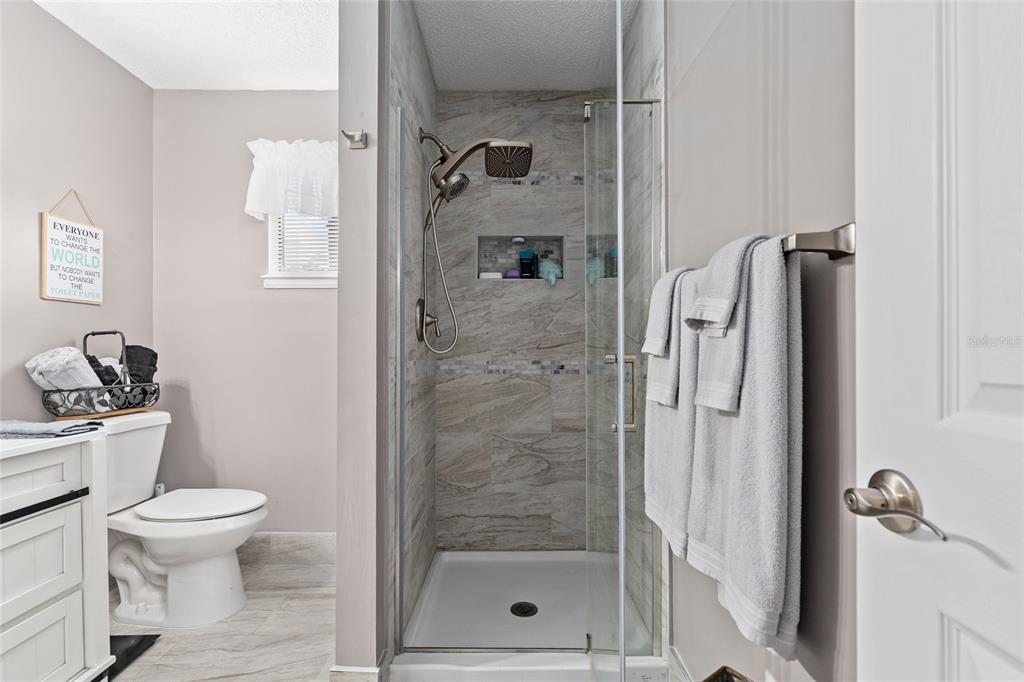 10182 Southwest 88th Court Ocala, FL 34481 - Photo 24 of 31 a bathroom with a shower a toilet and a sink