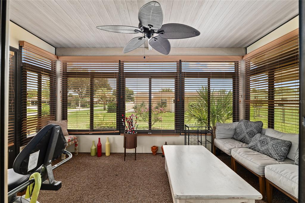 10182 Southwest 88th Court Ocala, FL 34481 - Photo 25 of 31 a living room with furniture and floor to ceiling windows