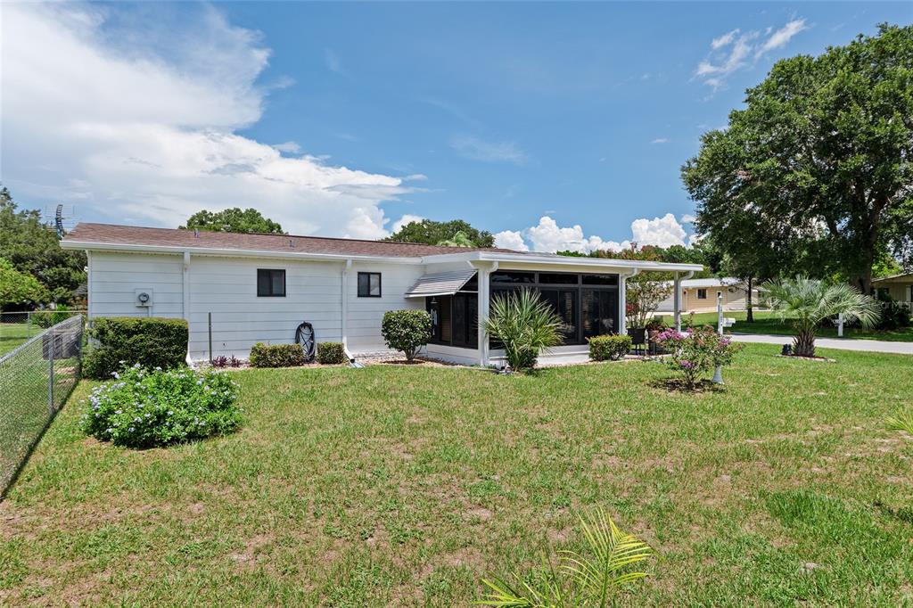 10182 Southwest 88th Court Ocala, FL 34481 - Photo 28 of 31 a front view of house with a garden and trees