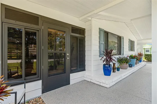 a view of a house with potted plants