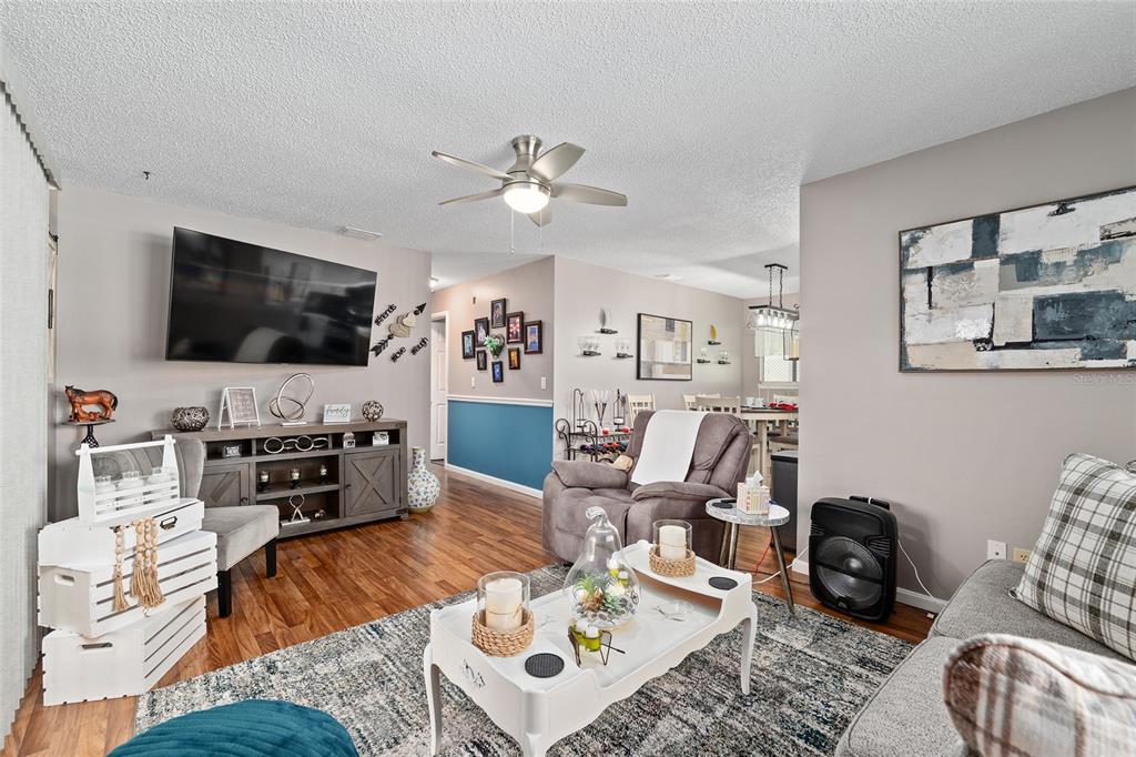 10182 Southwest 88th Court Ocala, FL 34481 - Photo 9 of 31 a living room with furniture and a flat screen tv