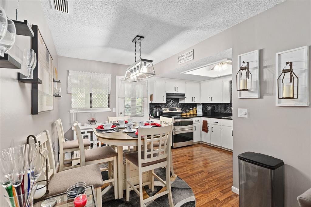 10182 Southwest 88th Court Ocala, FL 34481 - Photo 10 of 31 a kitchen with stainless steel appliances kitchen island granite countertop a sink and cabinets