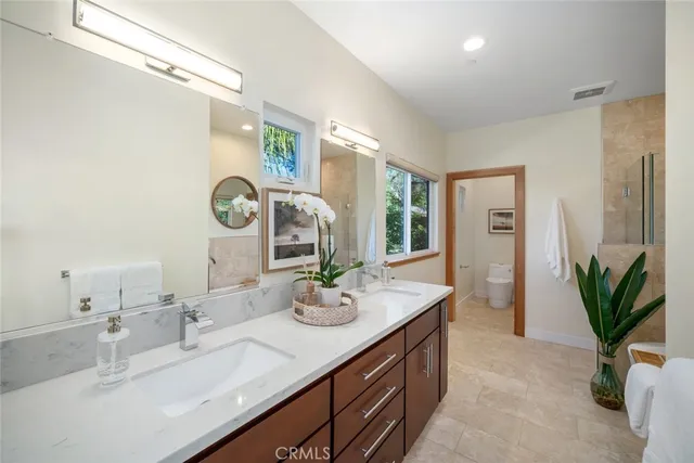a bathroom with a double vanity sink and a mirror