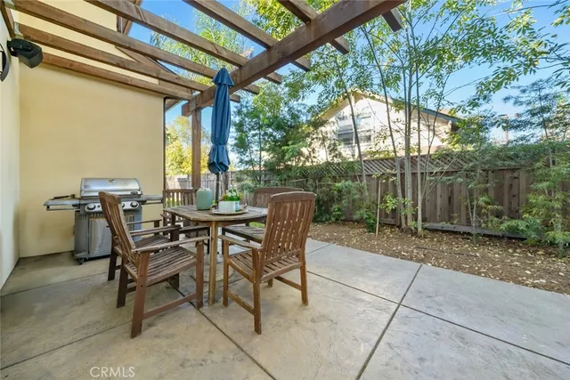 a view of a patio with a table and chairs