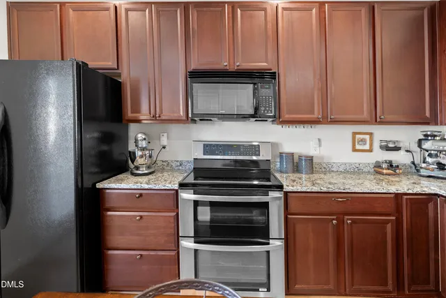 a kitchen with a sink stove and microwave