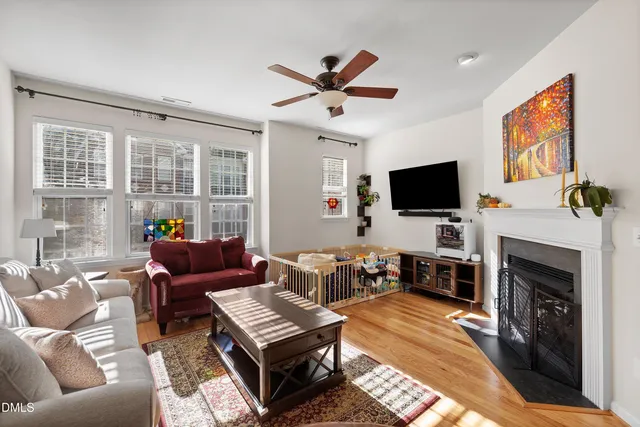 a living room with furniture a rug and a chandelier