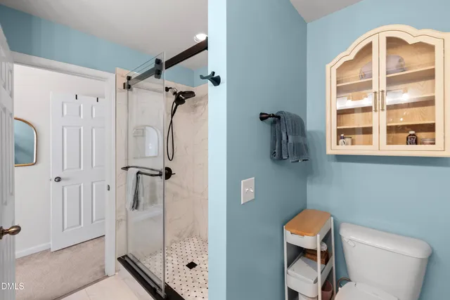 a bed room with a bed window and a chair