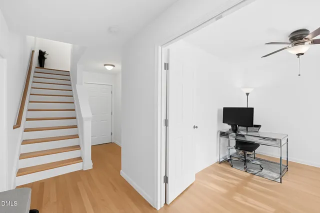 a view of a workspace with furniture and a window