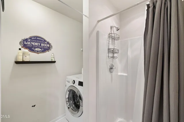 a close view of a utility room with dryer and washer