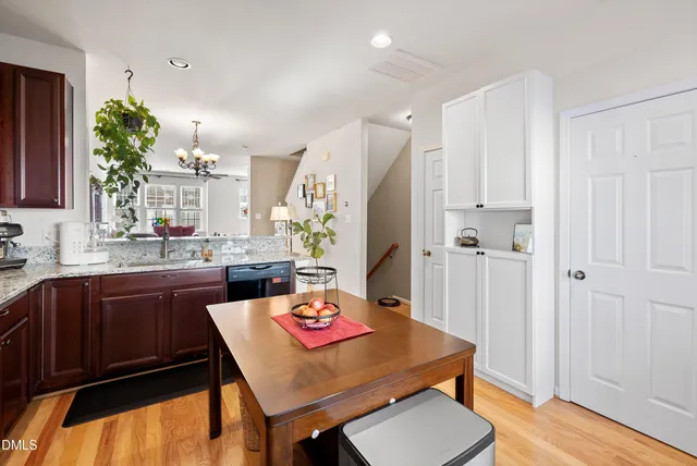 a kitchen with a stove a sink dishwasher and a refrigerator with wooden cabinets