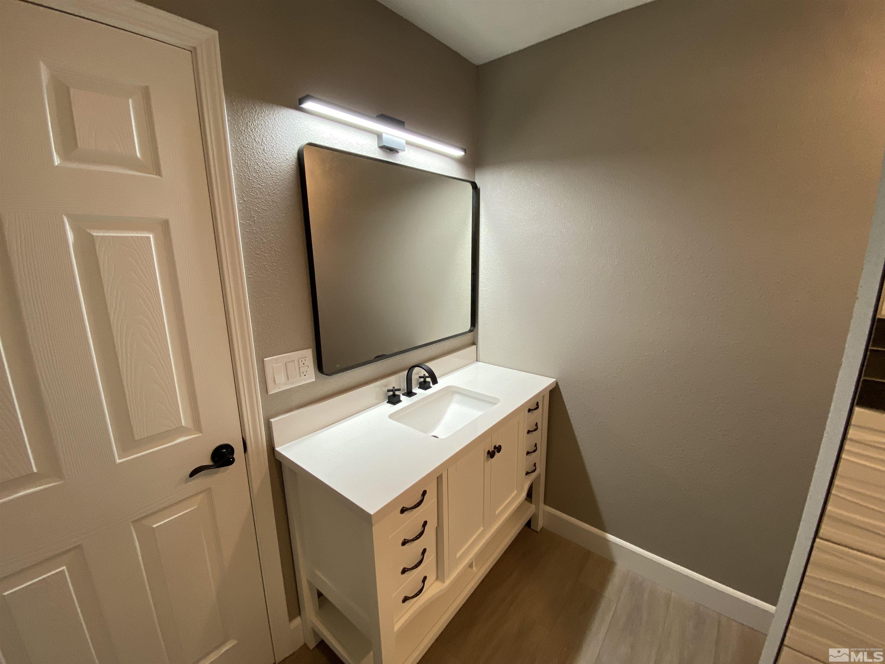 4035 Jasper Lane Reno, NV 89509 - Photo 16 of 16 a bathroom with a double vanity sink and mirror