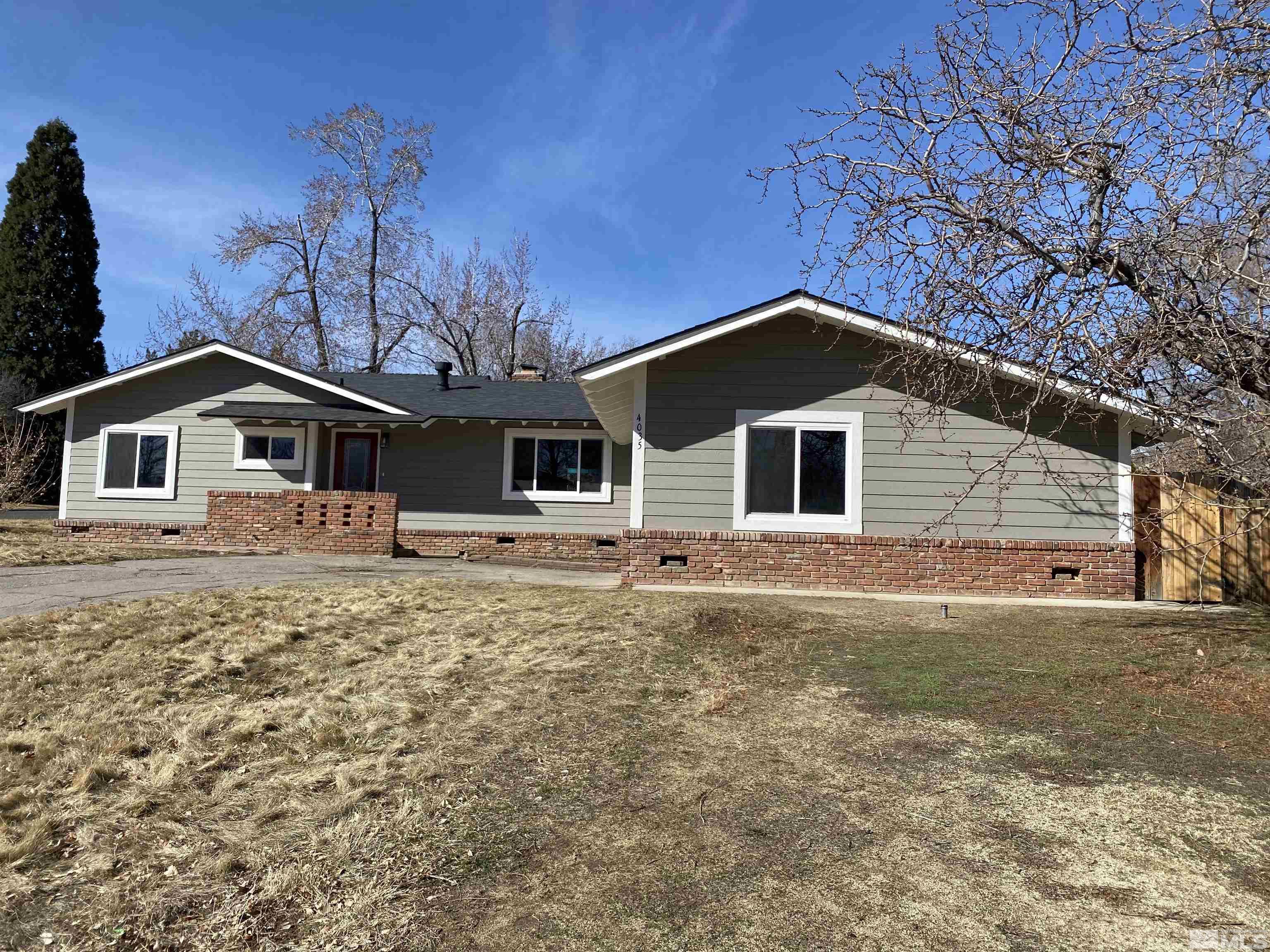 4035 Jasper Lane Reno, NV 89509 - Photo 3 of 16 a front view of a house with a yard