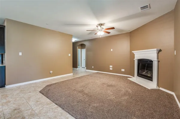 a view of an empty room with a fireplace