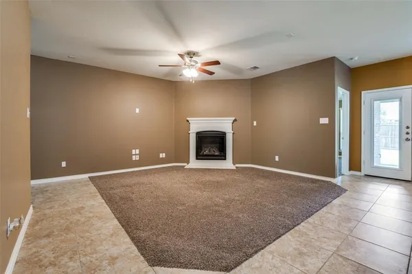 a view of an empty room with a fireplace