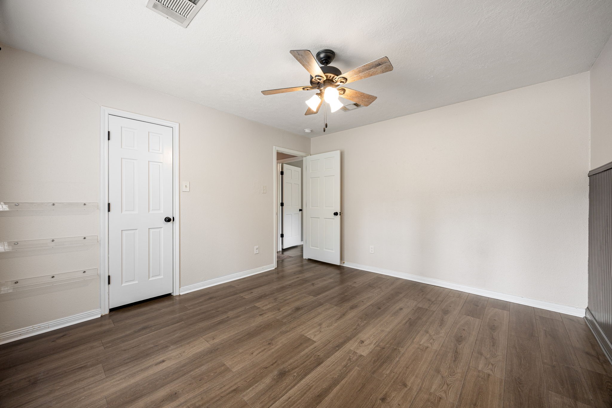 5527 Alamosa Lane Spring, TX 77379 - Photo 19 of 40 an empty room with wooden floor and fan