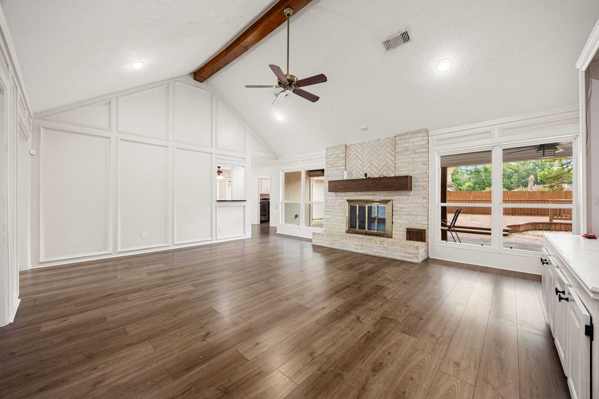 5527 Alamosa Lane Spring, TX 77379 - Photo 4 of 40 an empty room with wooden floor fireplace and windows